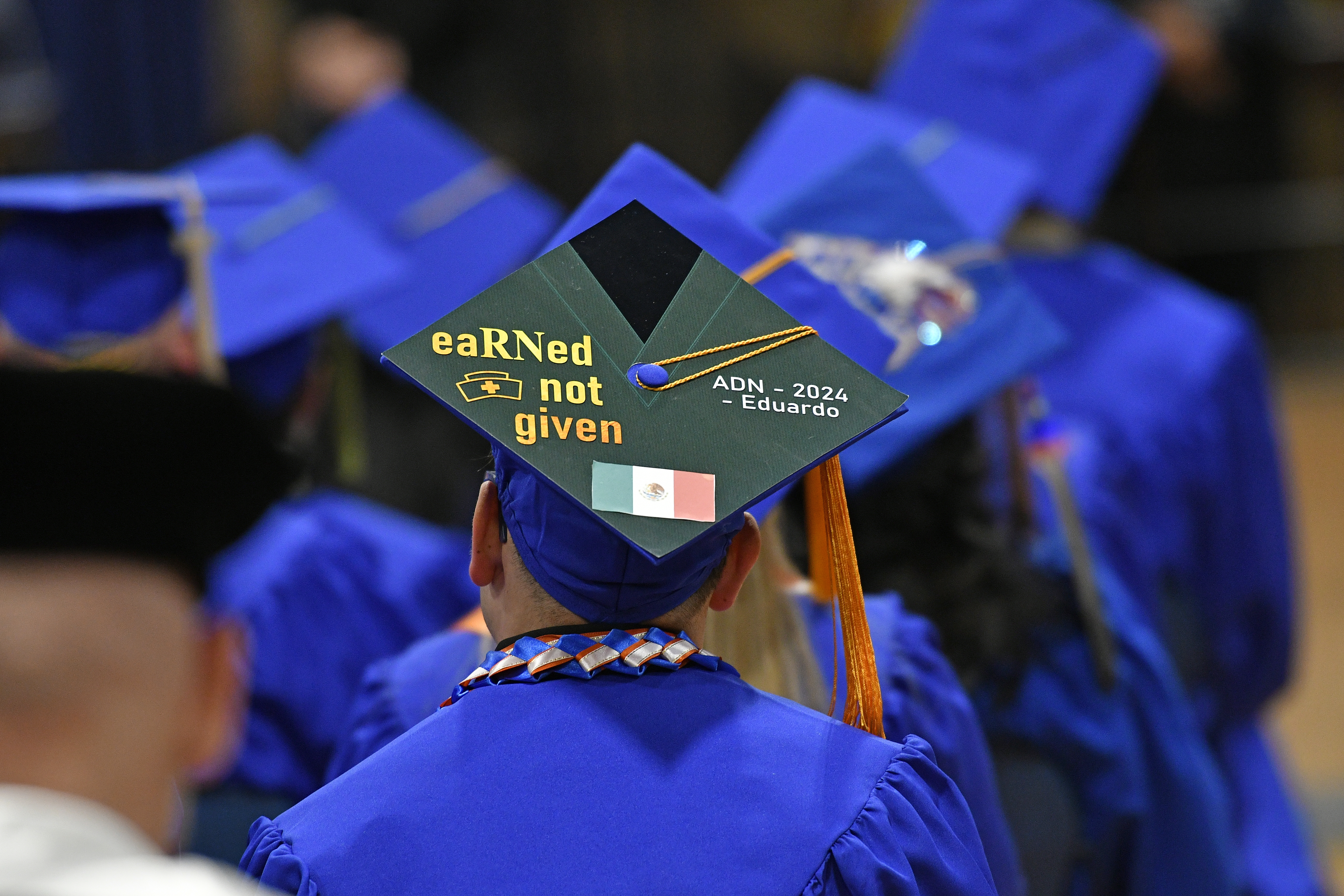 A graduation cap that reads "eaRNed not given" ADN 2024 graduate